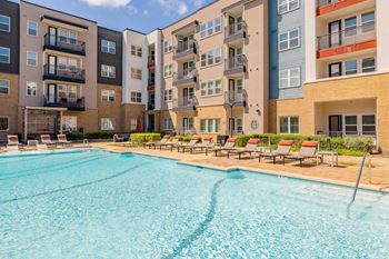 A large swimming pool in front of apartment buildings. at Bridge at Henley, Austin